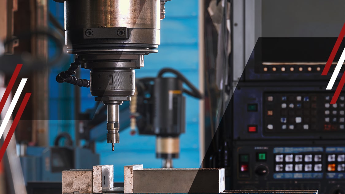 CNC milling machine spindle and cutting tool above metal workpiece, with control panel in background