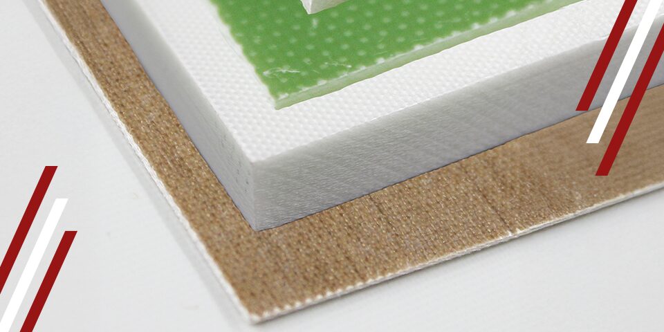 Stacked laminate sheets showing green, white, and brown textured garolite material corner close-up