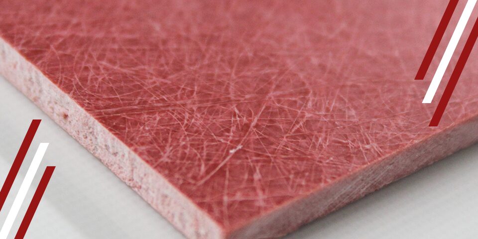 Close-up of red glass polyester laminate sheet showing fibrous texture and layered edge with diagonal stripes in corners